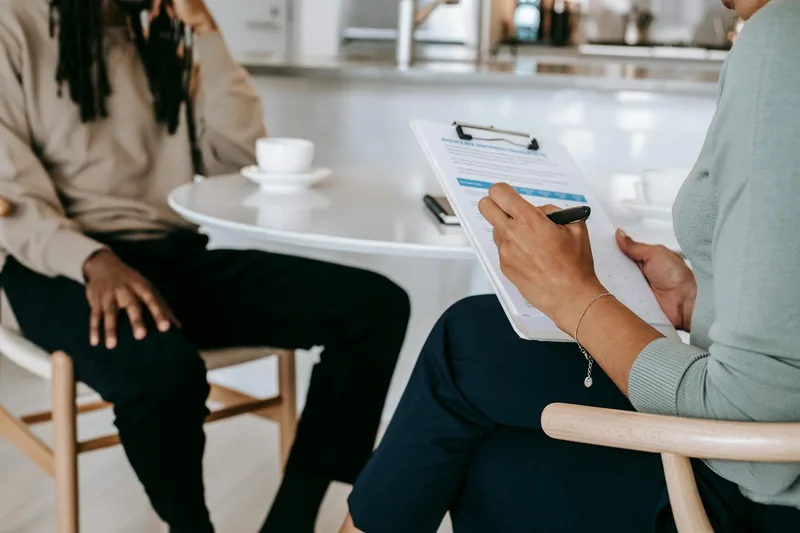 A focused individual reviewing customer research notes — the opposite of building in isolation