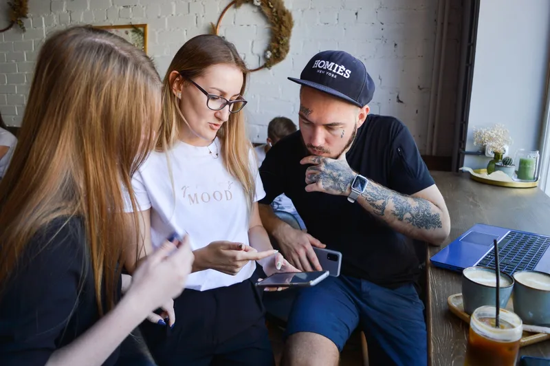 A group of people in a cafe discussing and sharing ideas enthusiastically