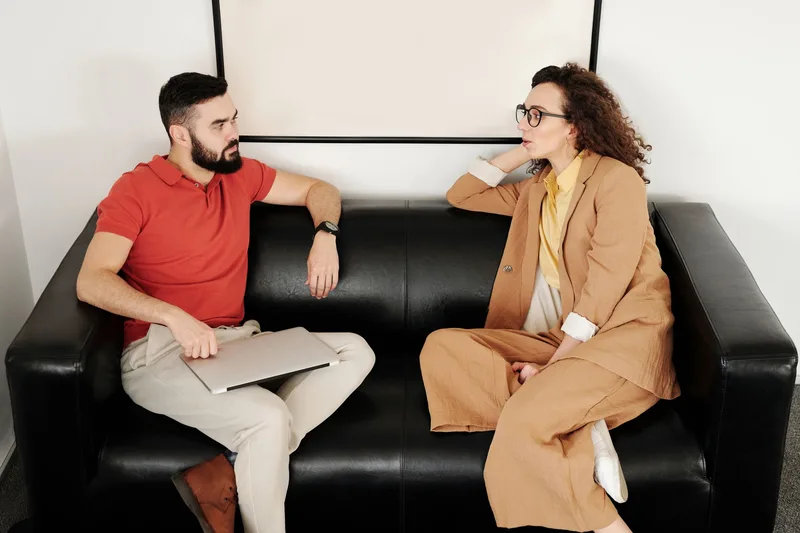 Two people in conversation — one asking honest questions about behavior, not opinions