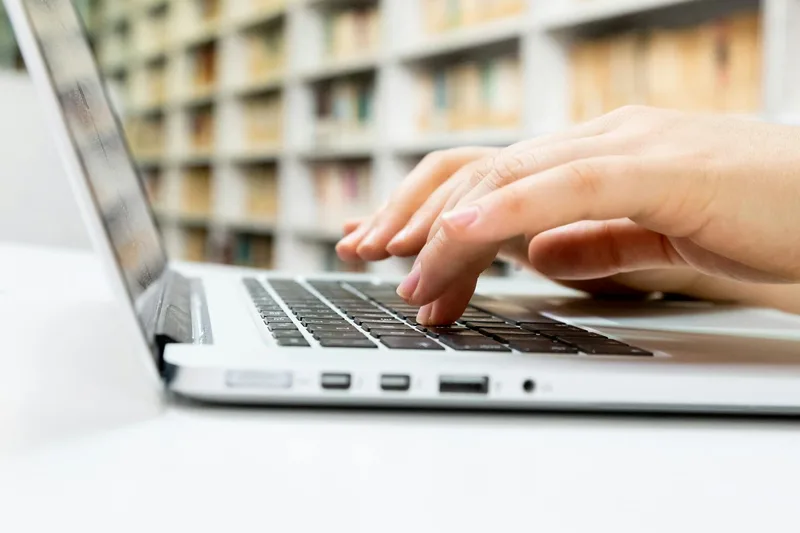 A person reviewing forum posts and reviews on a laptop, collecting documented evidence that a problem is real