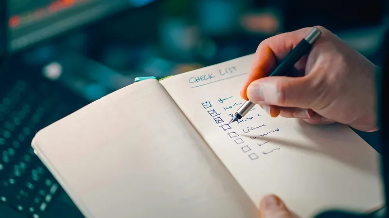 A simple notebook page with three handwritten questions and checkboxes: &ldquo;Specific problem named?&rdquo;, &ldquo;Five potential buyers interviewed?&rdquo;, &ldquo;Pre-commitment received?&rdquo;