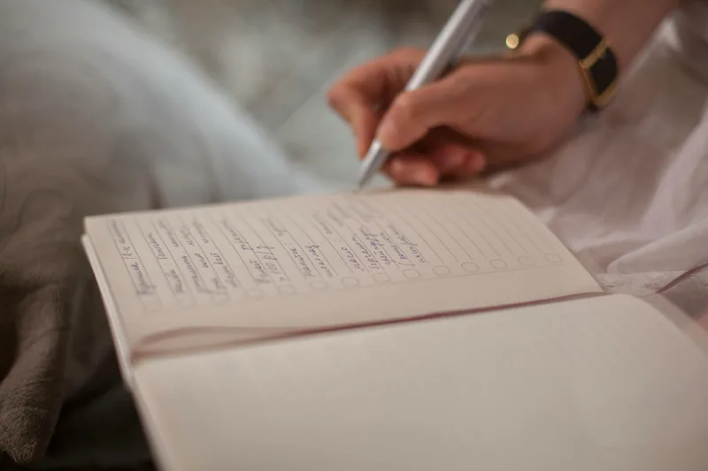 A notebook with structured interview questions — representing customer discovery before building anything
