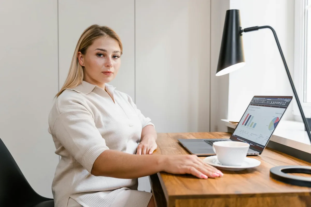 A solo founder reviewing launch metrics on a laptop at a desk